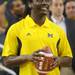 Michigan junior quarterback Denard Robinson looks to throw a football across the court and into the basket during a taping of ESPN's College Game Day at Crisler Arena on Saturday morning. Melanie Maxwell I AnnArbor.com